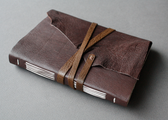 Longstitch binding with a leather strap